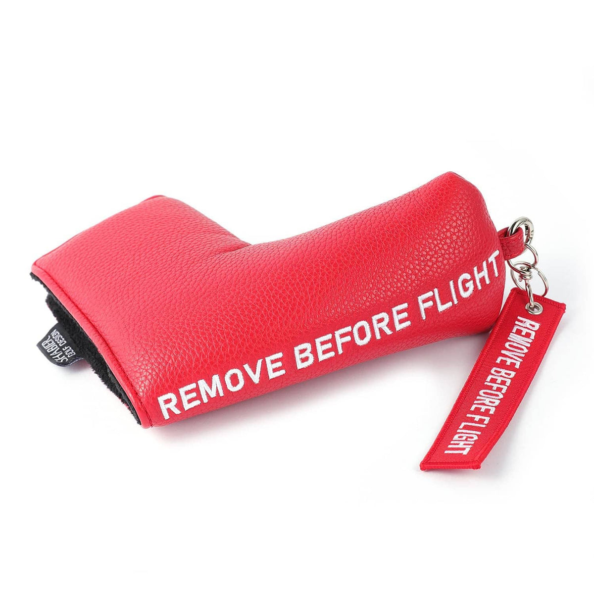 Red blade golf putter cover with black lining and "Remove Before Flight" strap