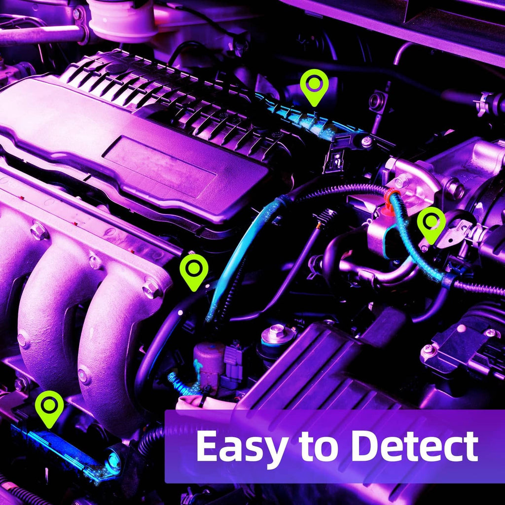UV leak detector flashlight highlighting suspected AC leak area in engine bay