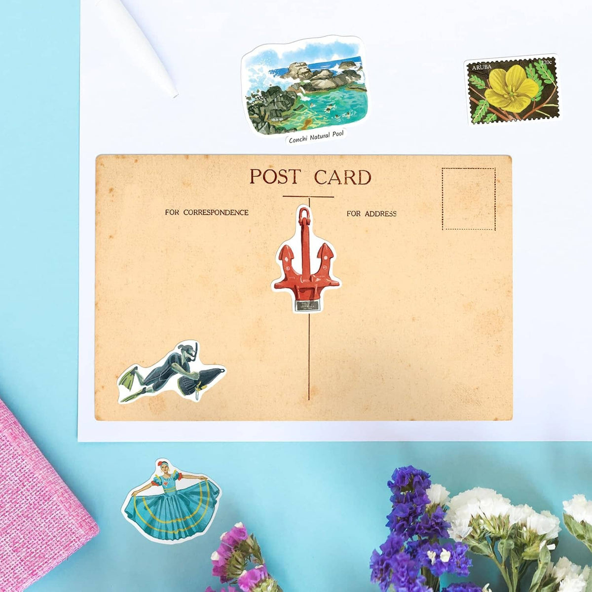 Postcard layout with Aruba stickers, including red lighthouse and sea views