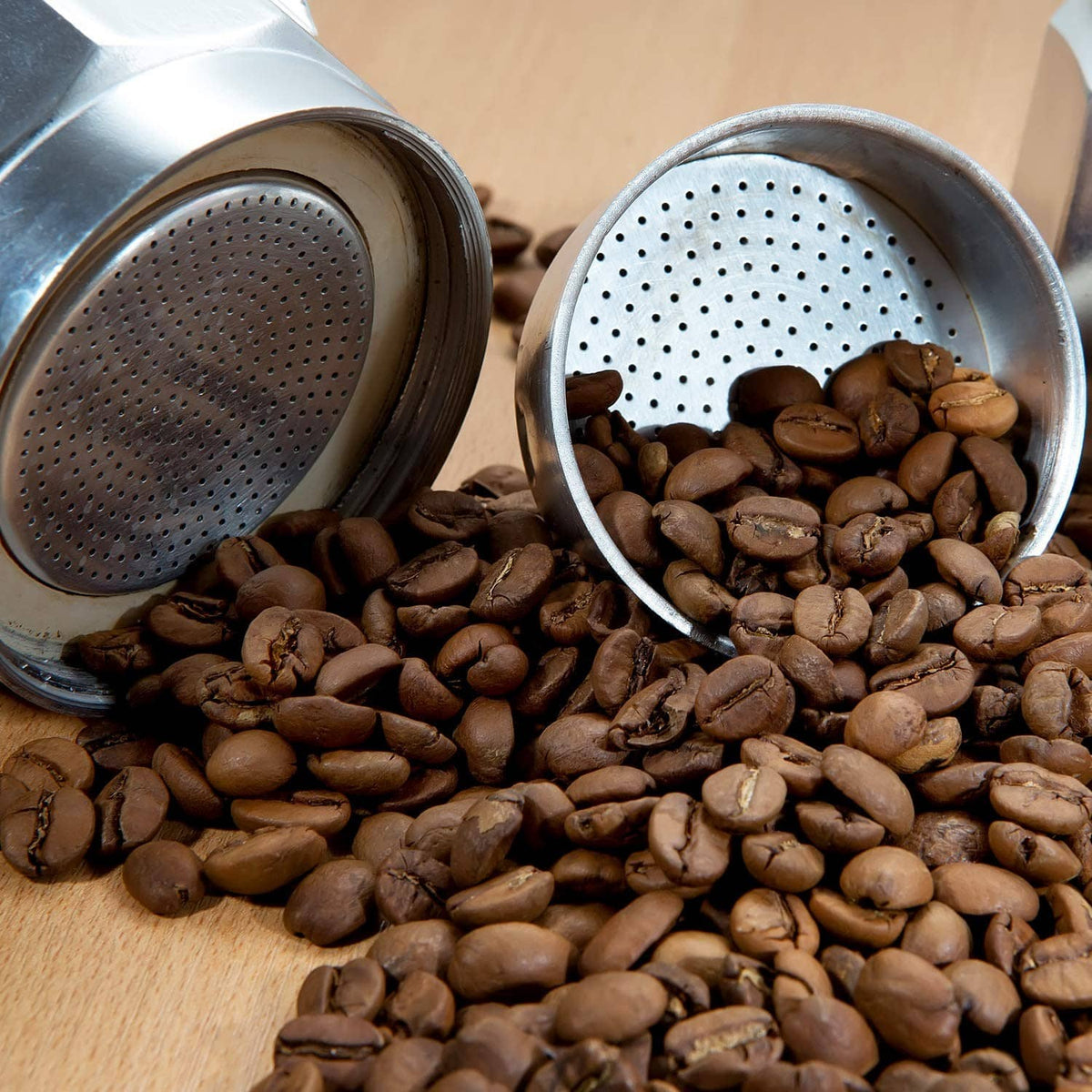 Stainless steel moka pot funnels filled with coffee grounds for replacement