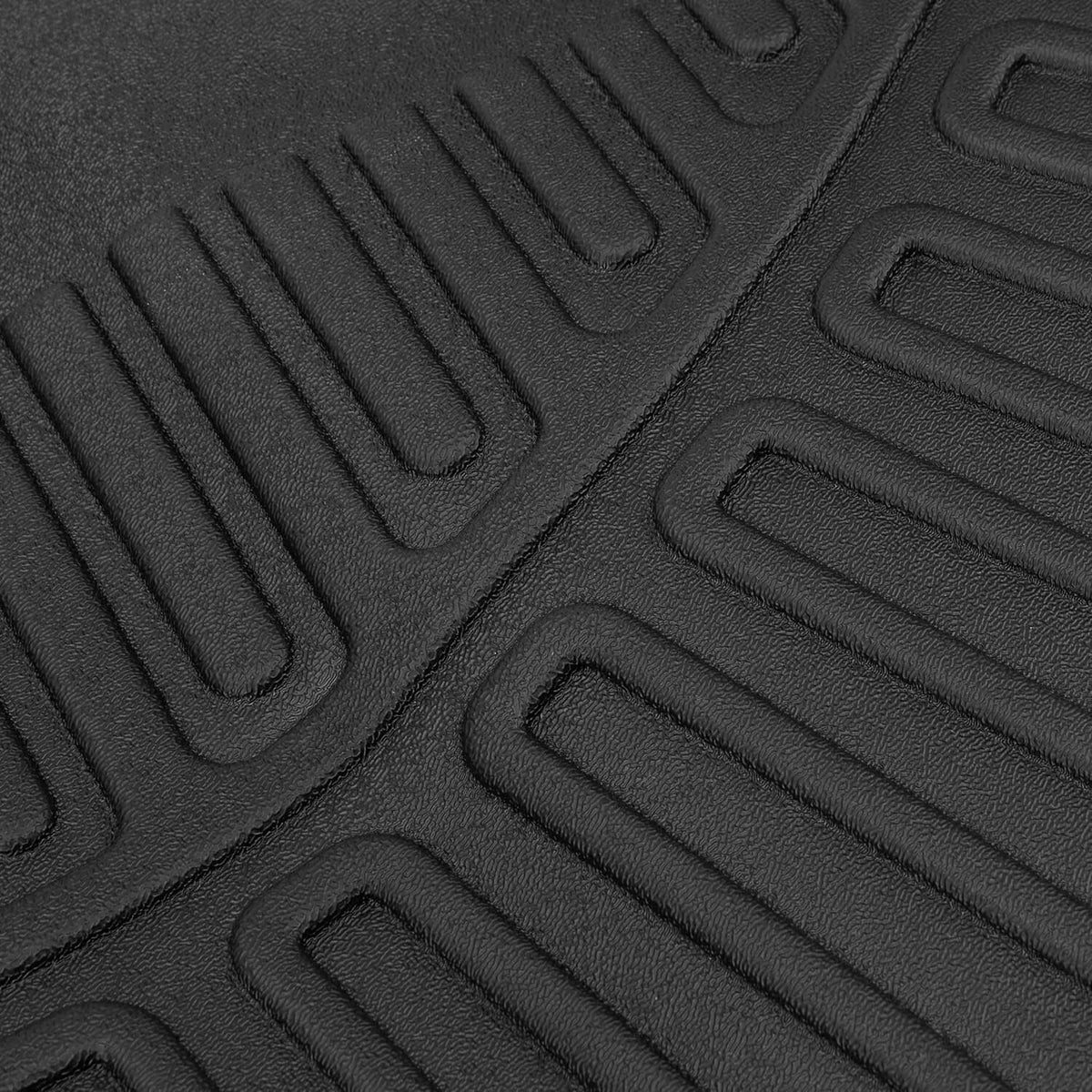 Close-up of black rubber floor mat texture with diagonal ribbed grooves