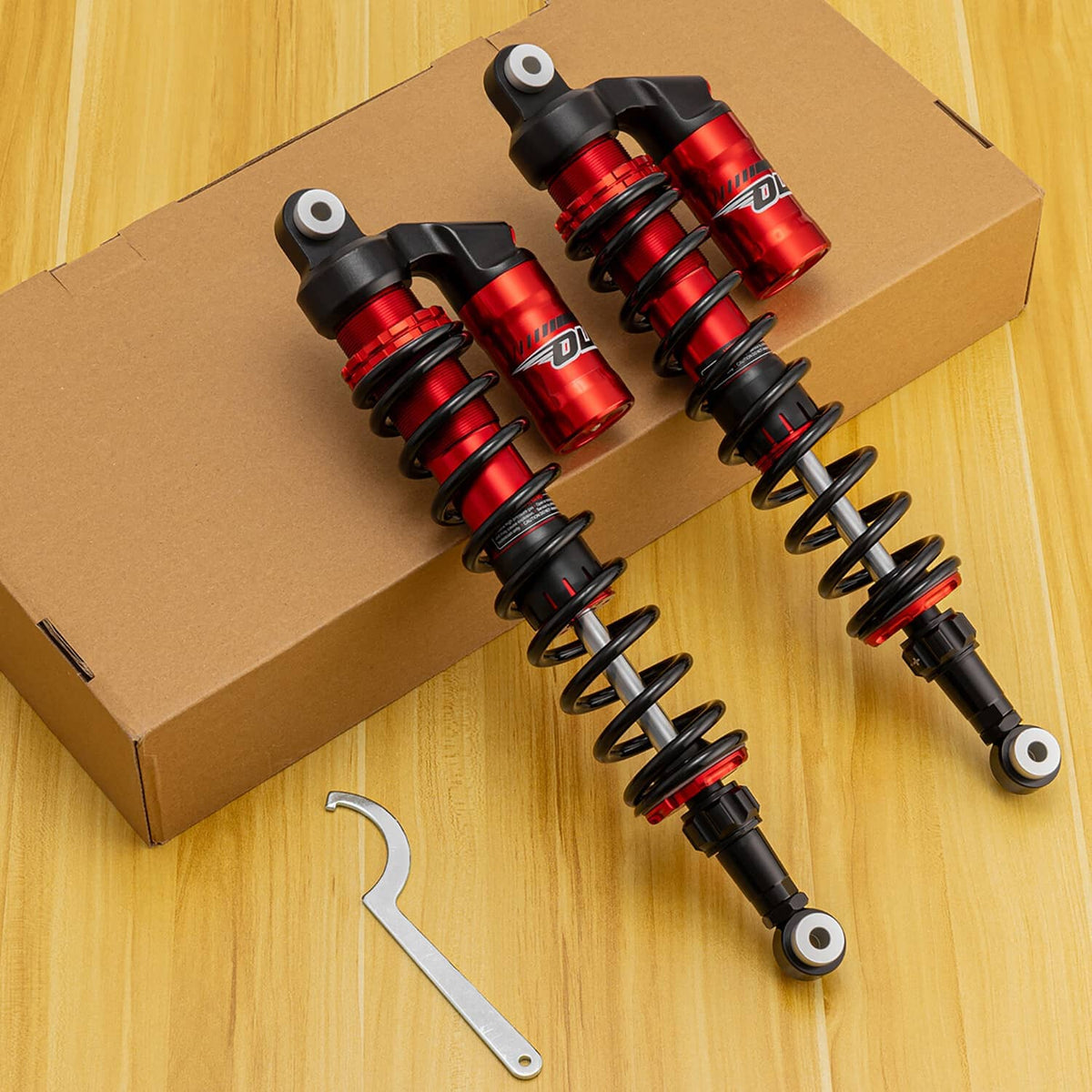 Pair of rear coil-over shocks: black coil springs, red reservoirs, mounting studs