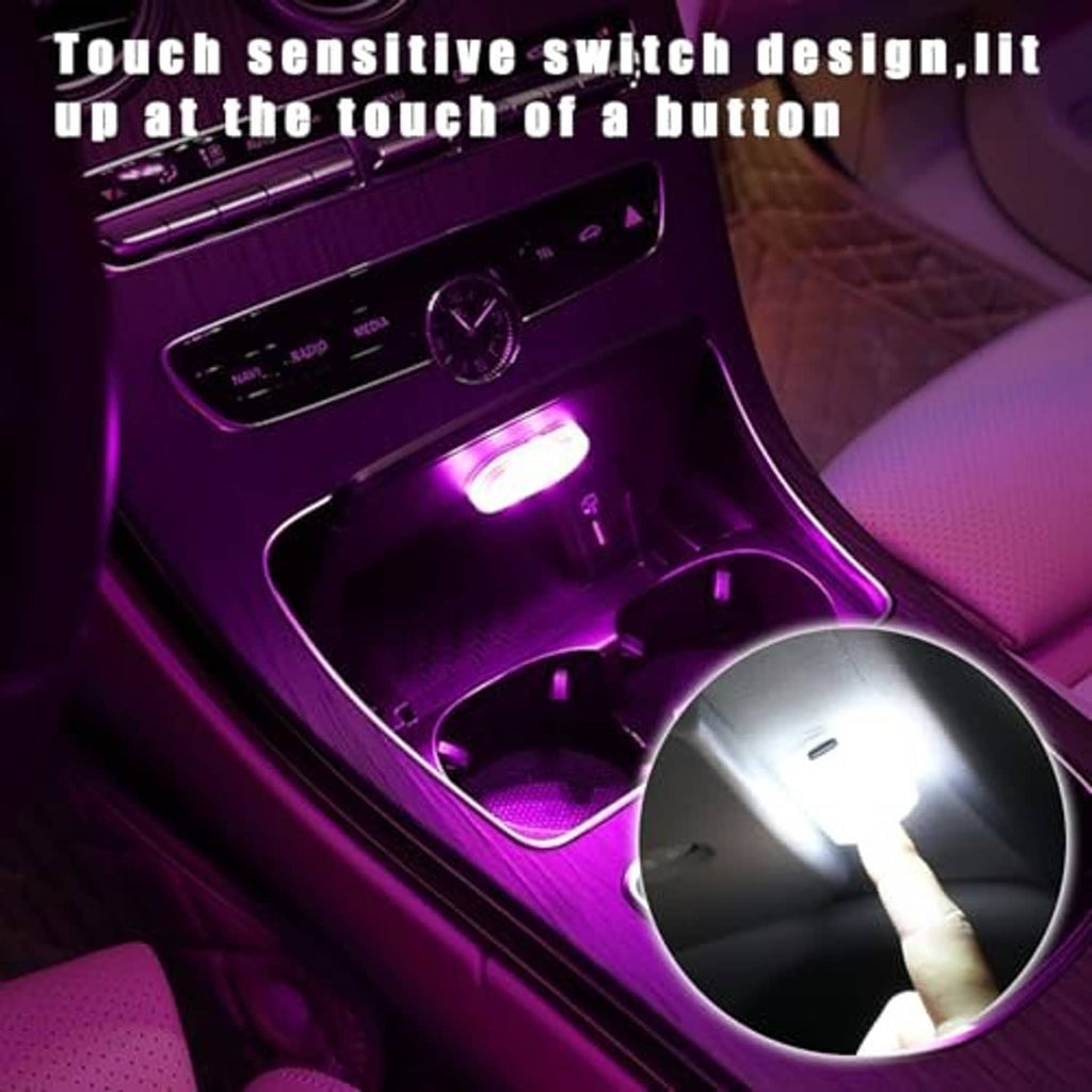 Magnetic LED car interior light glowing in purple near the dashboard console