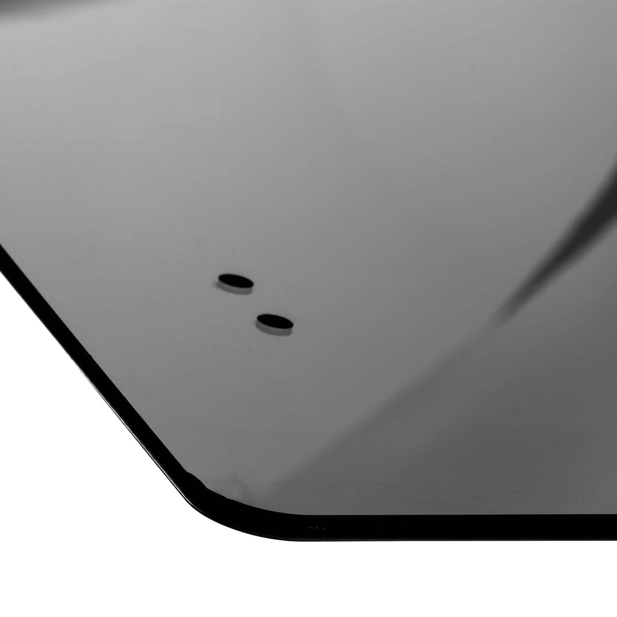 Close-up of tinted UTV rear windshield corner with black trim