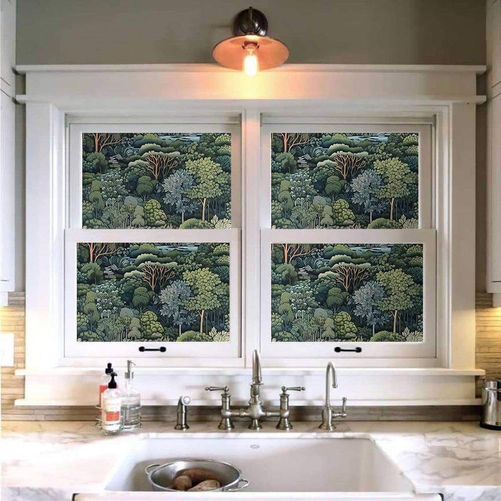 Green forest tree mural wallpaper on window panels above a kitchen sink