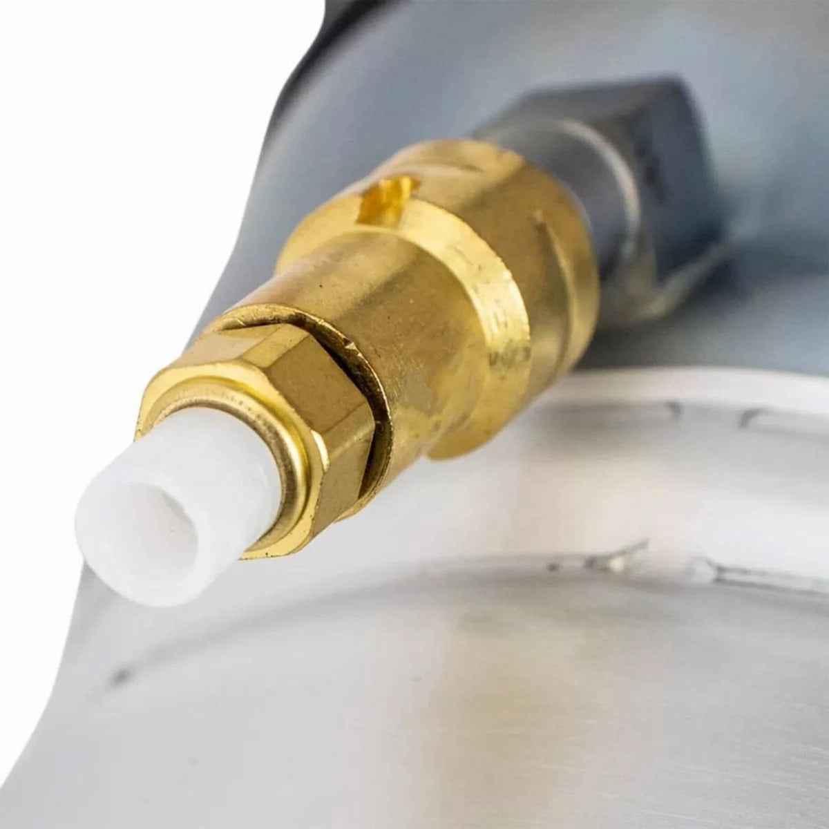 Close-up of brass valve fitting on silver air suspension shock strut