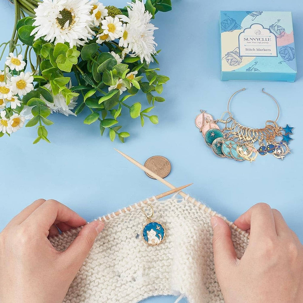 Planet stitch markers on knitted beanie, gold-tone rings with blue planet charms