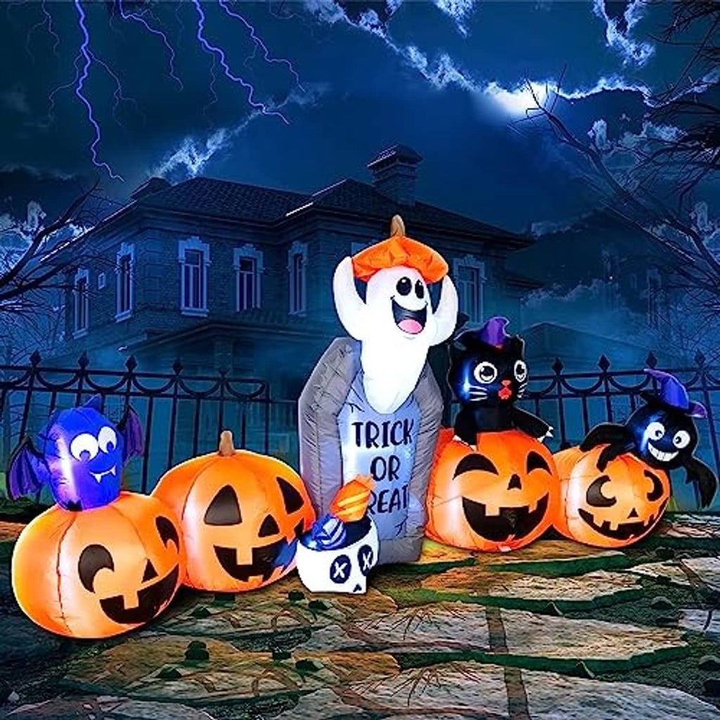 Nighttime Halloween inflatable set with ghost, black cat, and jack-o'-lantern pumpkins on walkway