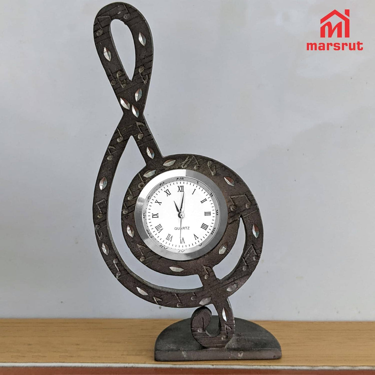 Clock face insert on black ornate base, silver rim, white dial with Roman numerals