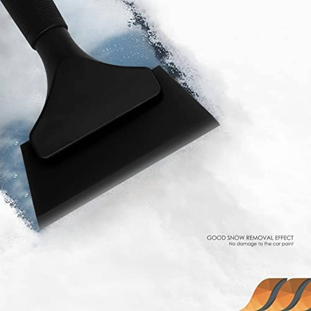 Black rubber squeegee removing water from a snowy windshield surface