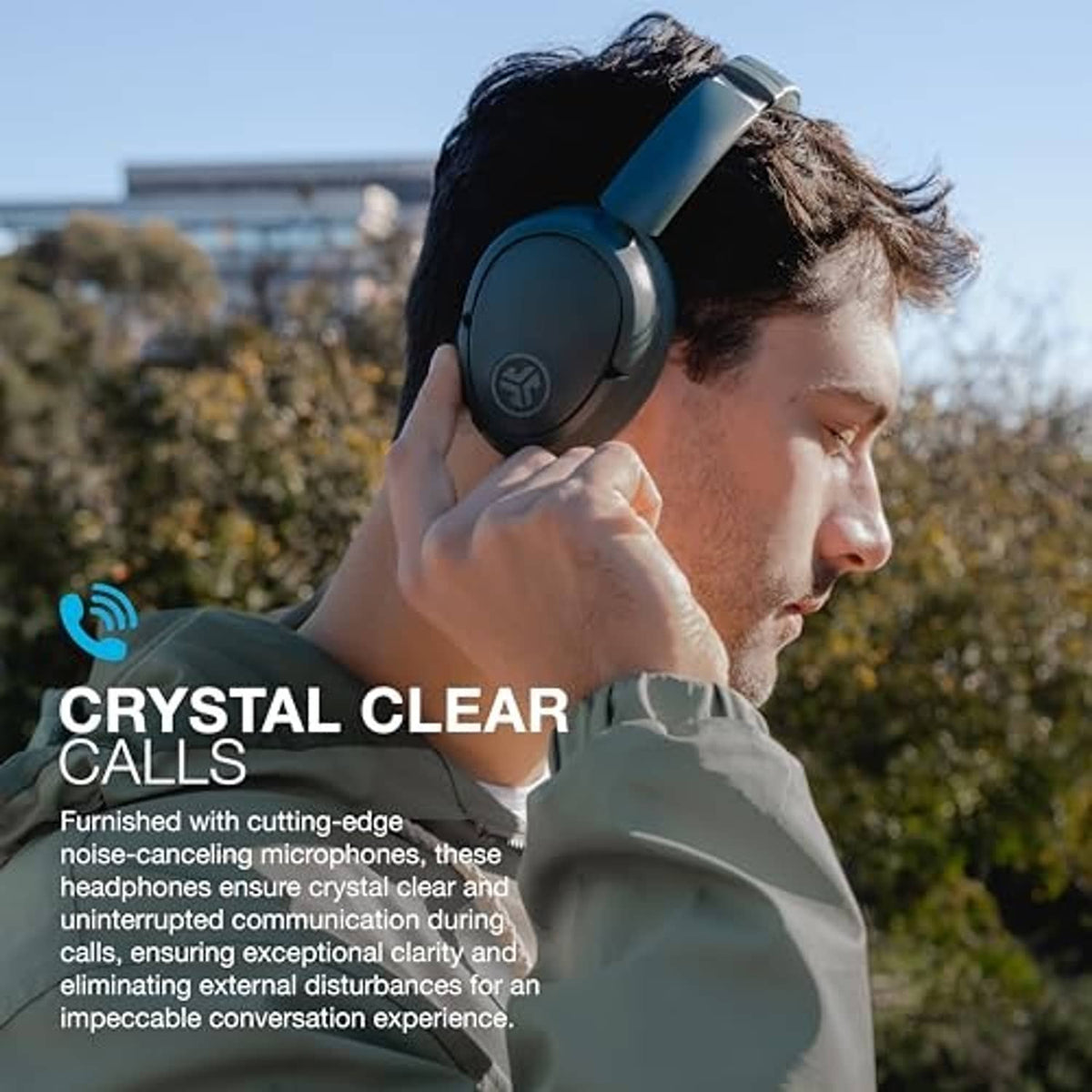Sage green over-ear headphones worn outdoors in a side view