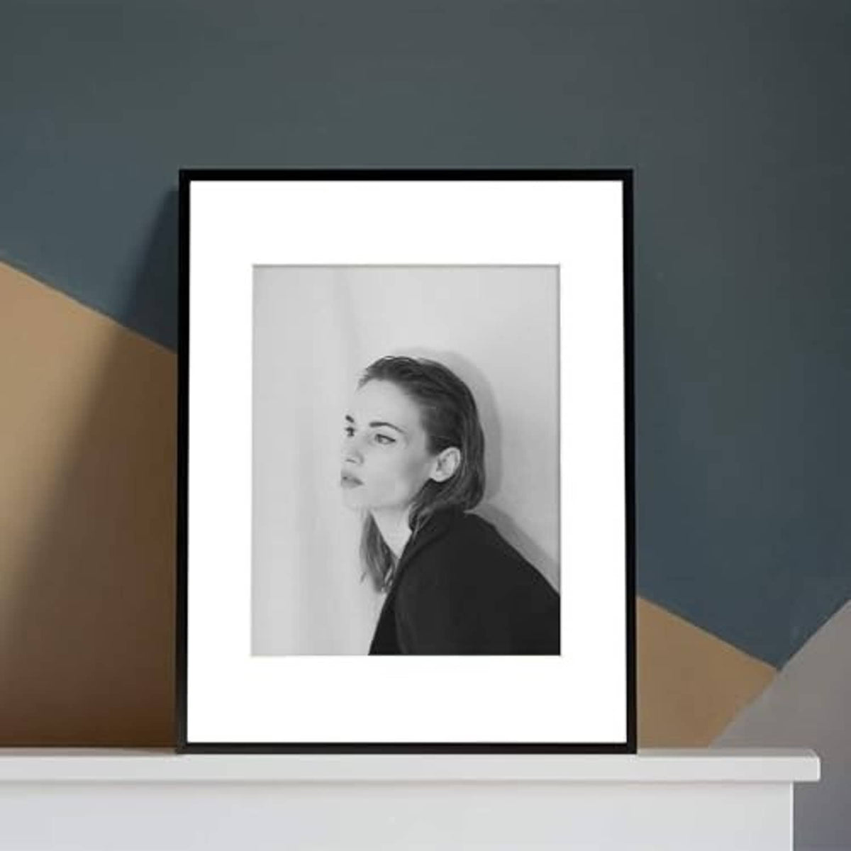 Black aluminum picture frame with white mat, grayscale portrait photo