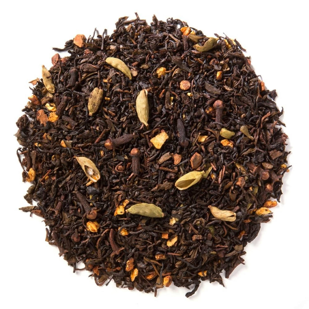 Loose leaf green chai tea blend with visible spices and orange peel pieces
