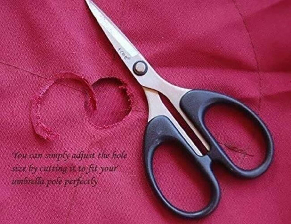 Red canopy fabric with cut hole area and scissors for adjusting center opening