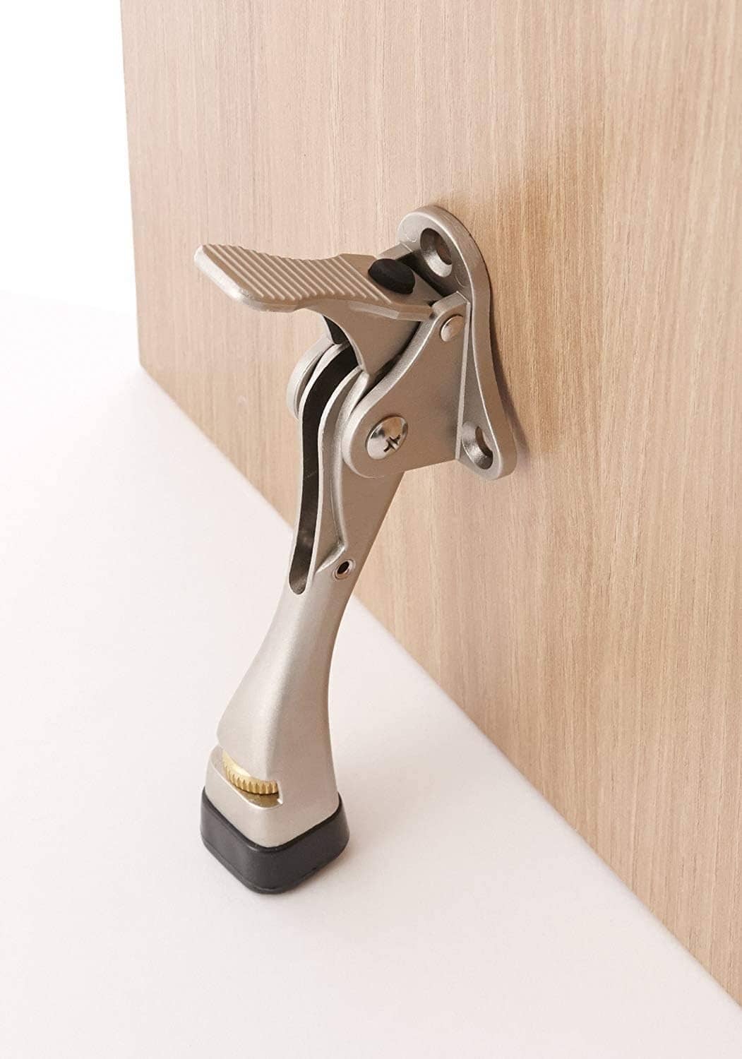 Mounted kickdown door stopper with hinged lever and rubber foot pad