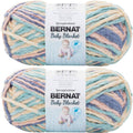 Soft baby blanket yarn skein in pastel stripes of blue, cream, and peach