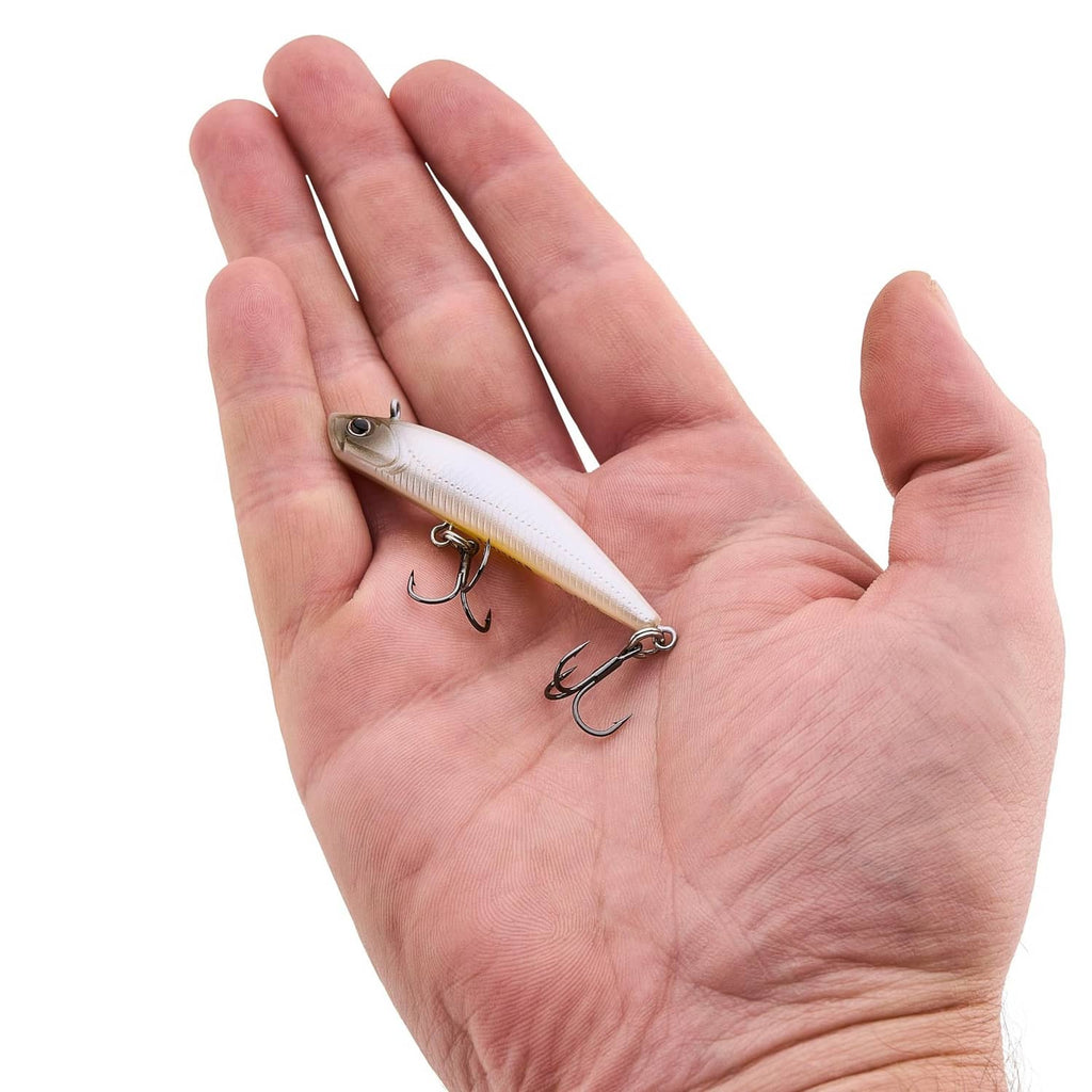 Berkley Finisher lure held in hand, small pearl white body with treble hooks