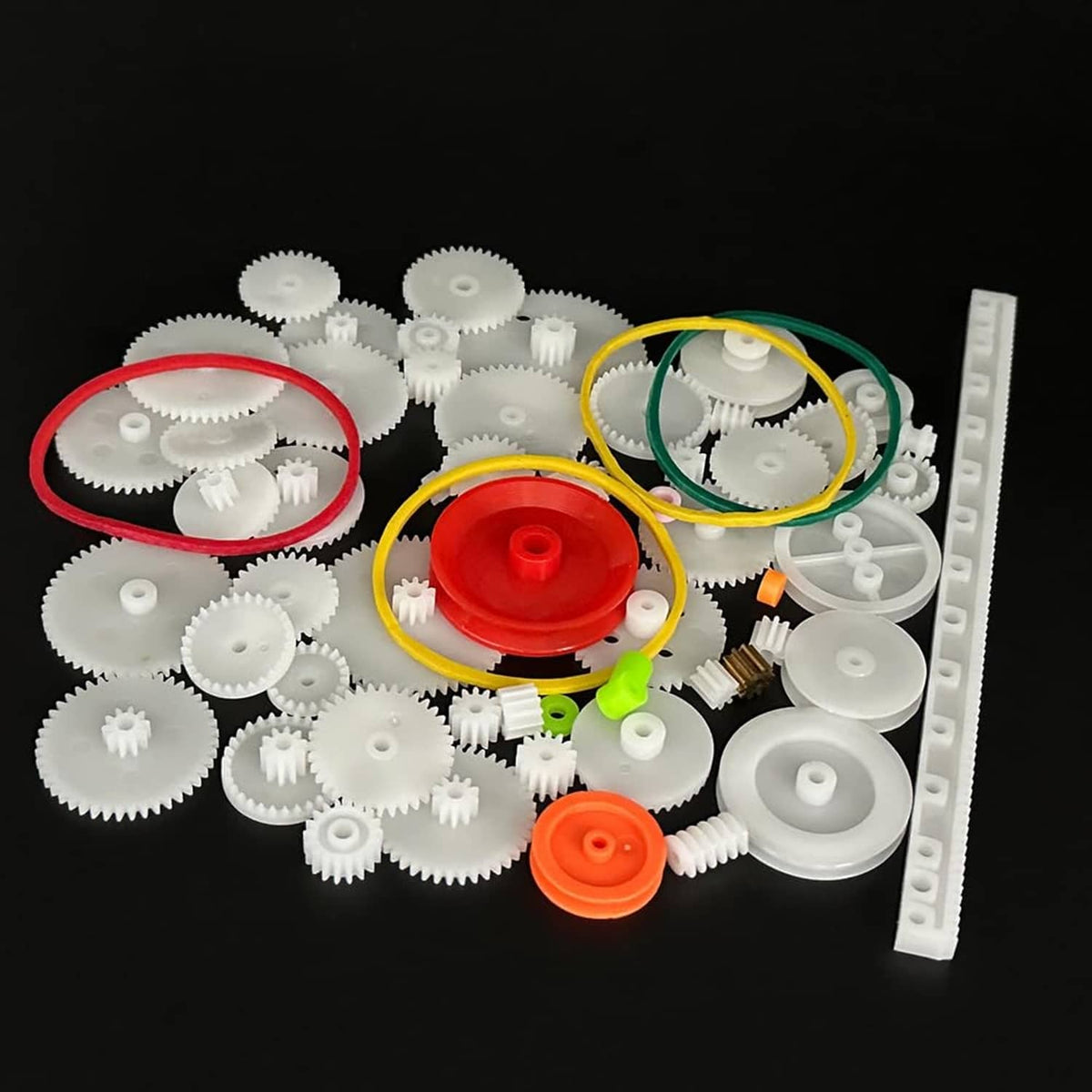 Plastic gear kit with white gears, red and orange pulleys, and colored belts