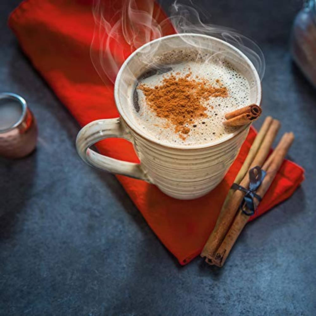 Instant herbal beverage mug with foamy crema and cinnamon-brown powder