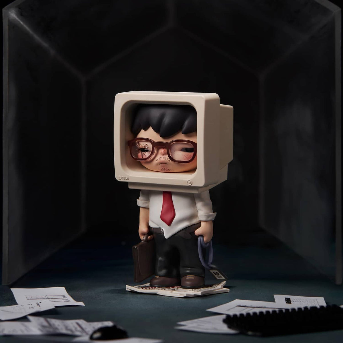 Tamed Hirono figure in goggles and a red tie outfit, standing on a small base