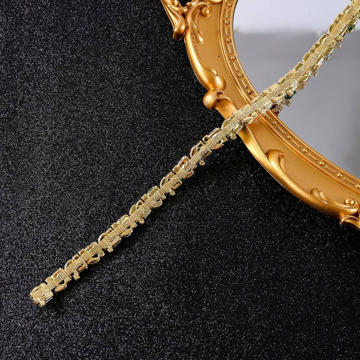 Gold rhinestone trim chain strand with repeating crystal links on an ornate frame