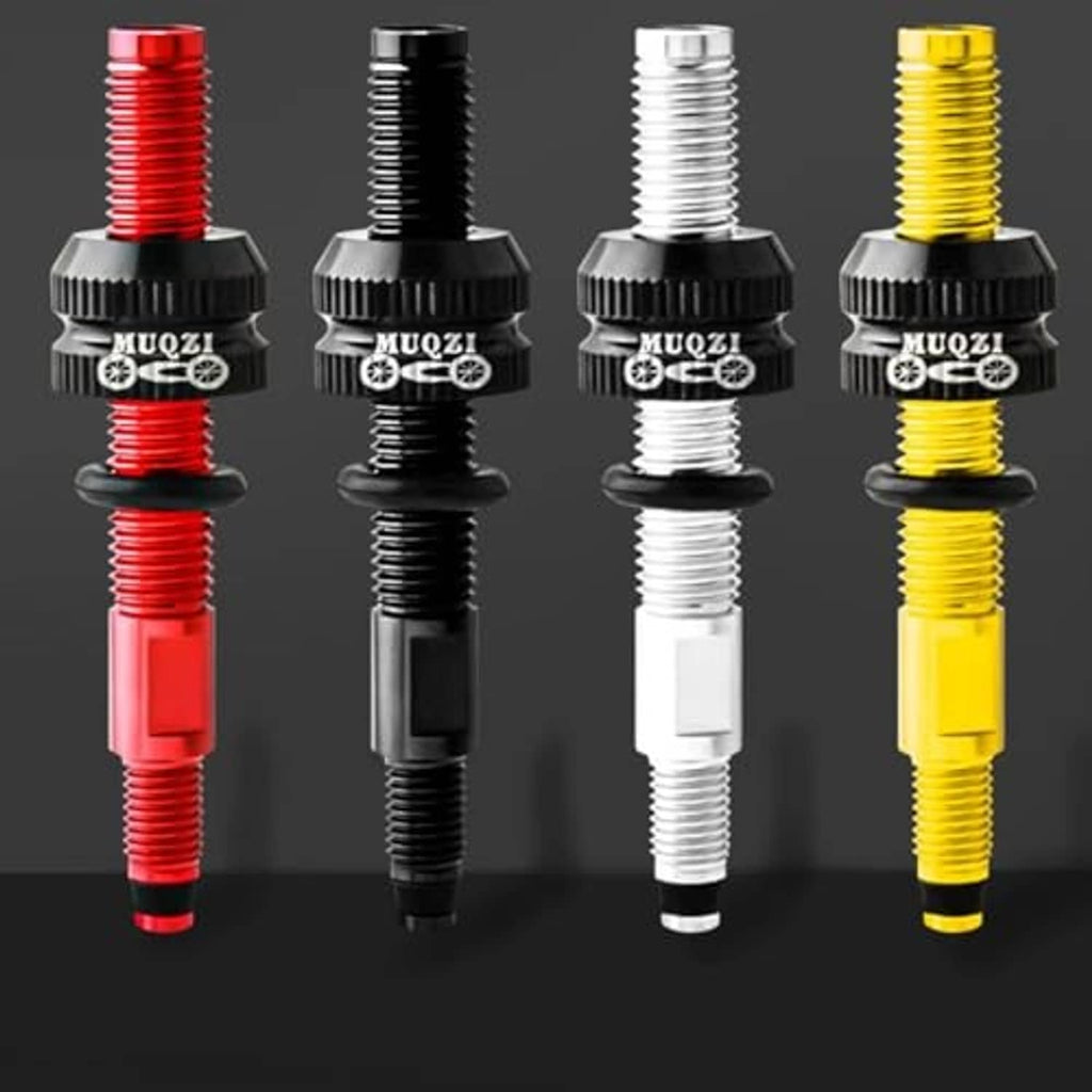 Tubeless bicycle valve extensions in red, black, white, and yellow with adapter base