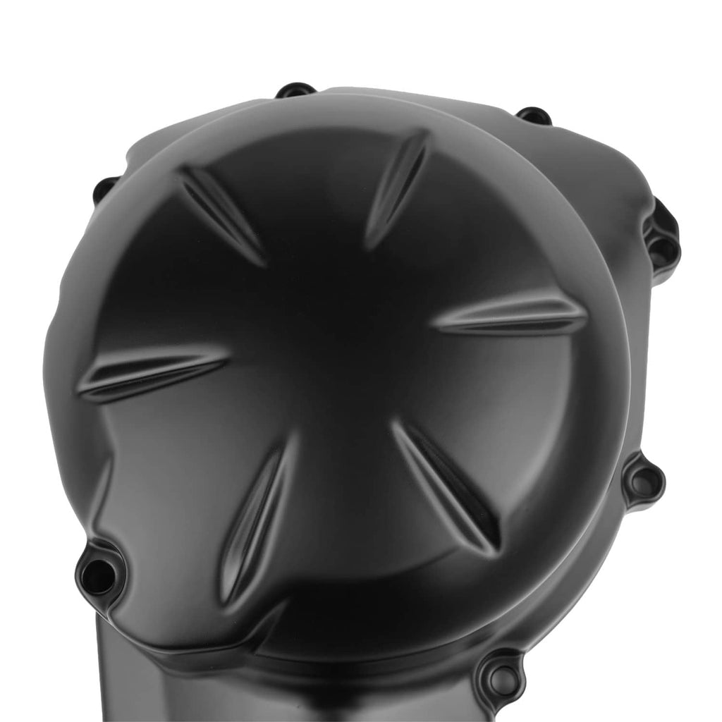 Black engine cover with starburst pattern and multiple bolt mounting points