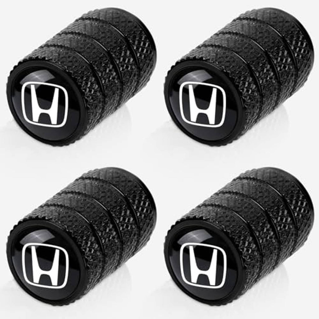 Four-pack black tire valve stem caps with white Honda emblem, angled view