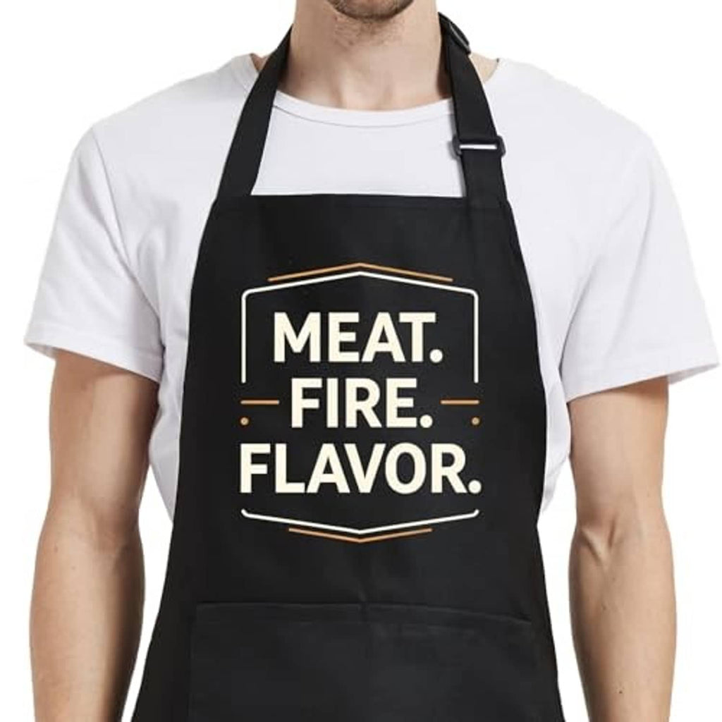 Black bib apron with “MEAT. FIRE. FLAVOR.” print and adjustable neck strap.