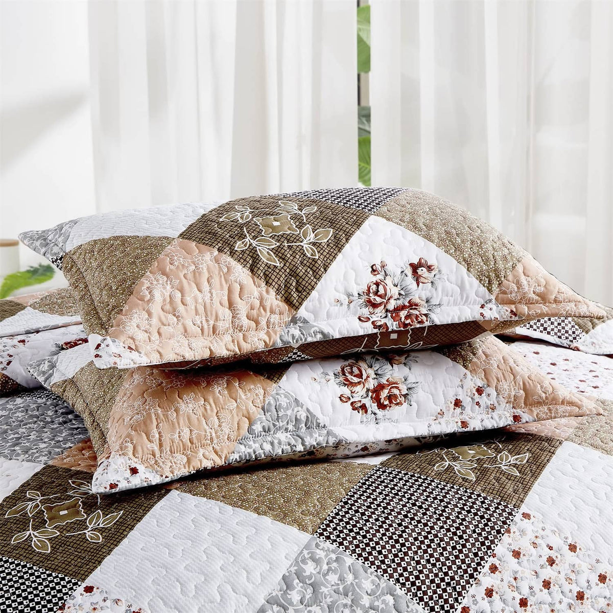 Twin quilt set with folded quilt layers and patchwork squares in brown, tan, and white