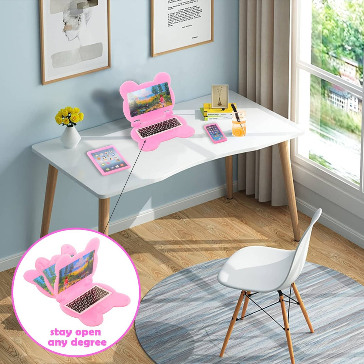 Kids doll electronics accessories on desk: pink laptops and tablet devices