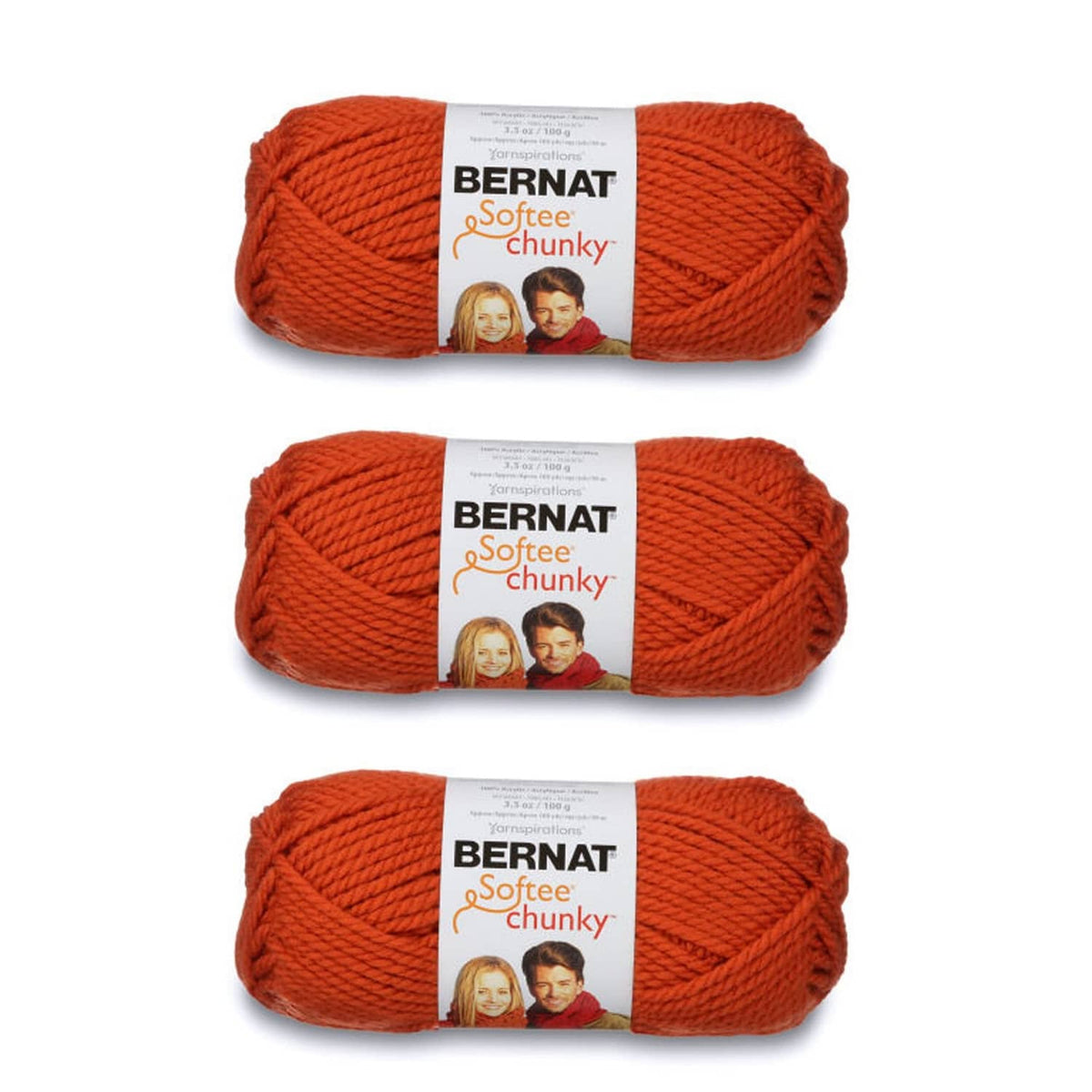 Three skeins of super bulky chunky yarn in solid orange, banded with labels
