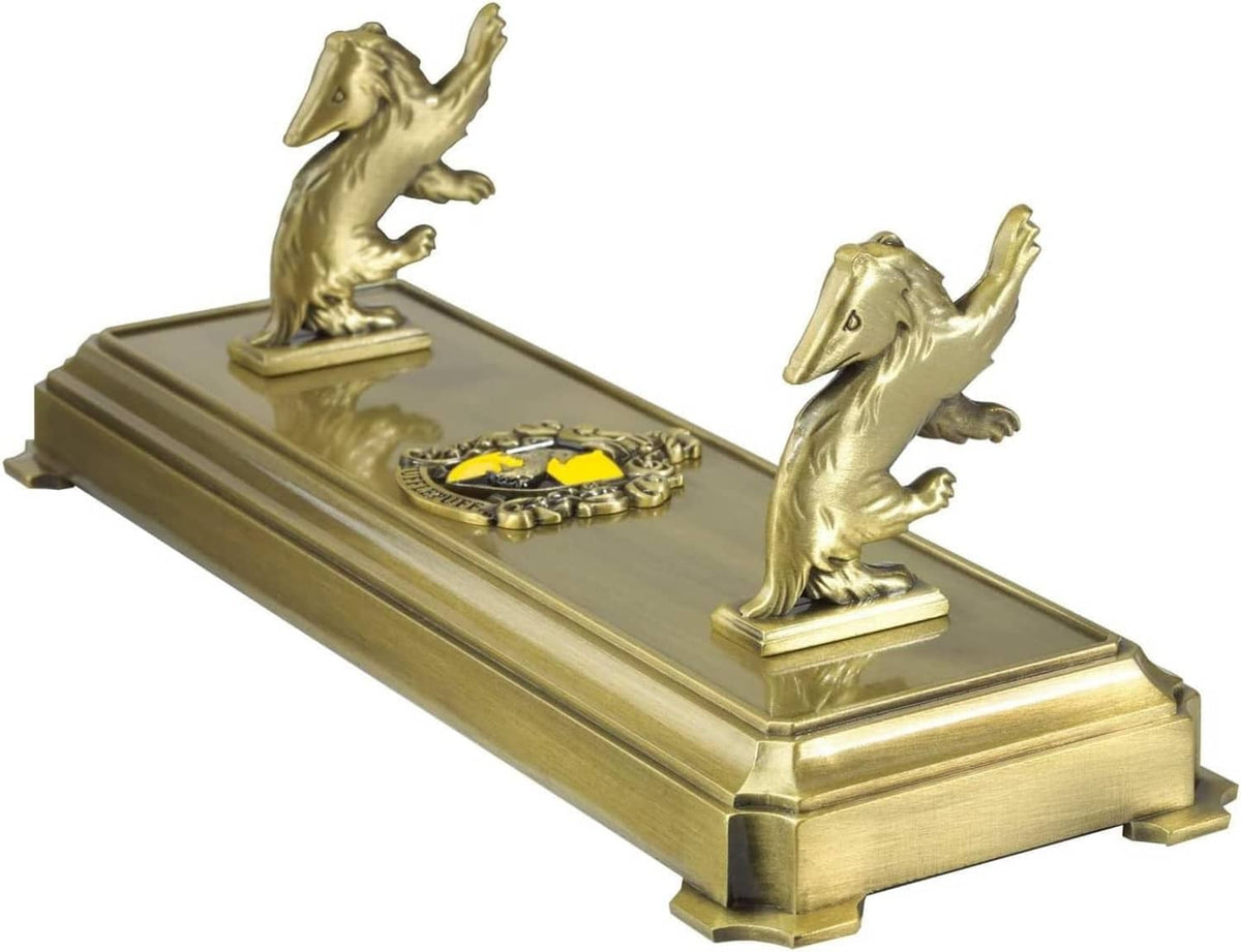 Gold-tone wand stand with two badger statues and circular emblem on the base
