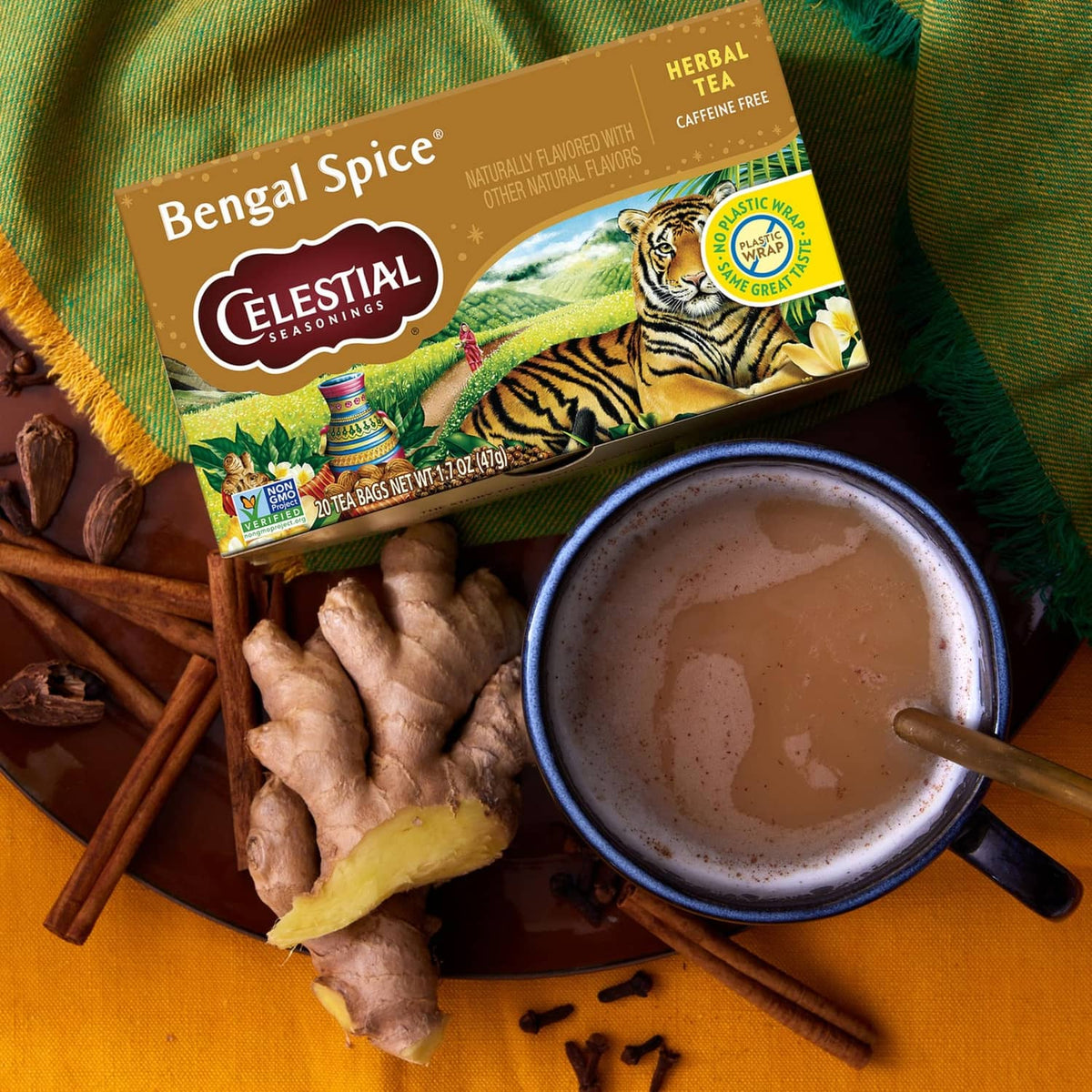 Celestial Bengal Spice herbal tea box with cup, ginger root, and cinnamon sticks