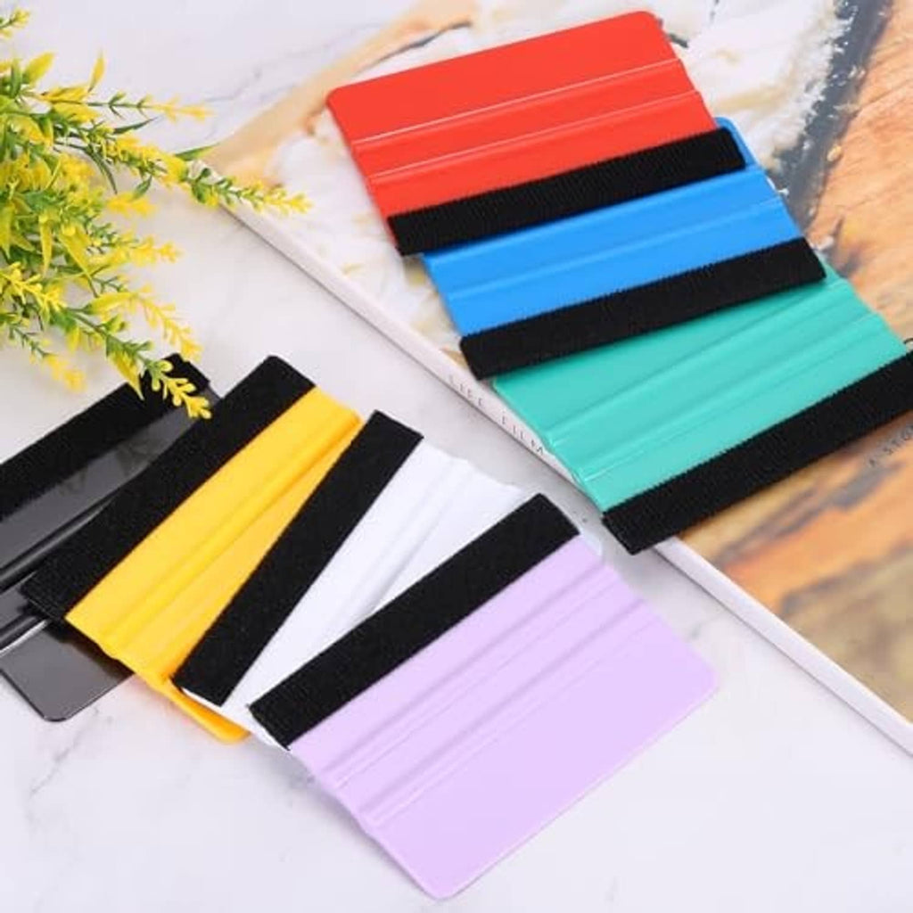 Assorted vinyl squeegees with felt edges and black straps, including purple
