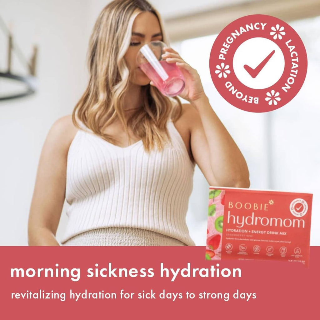 Hydromom strawberry kiwi hydration energy drink mix packet beside pregnant woman drinking