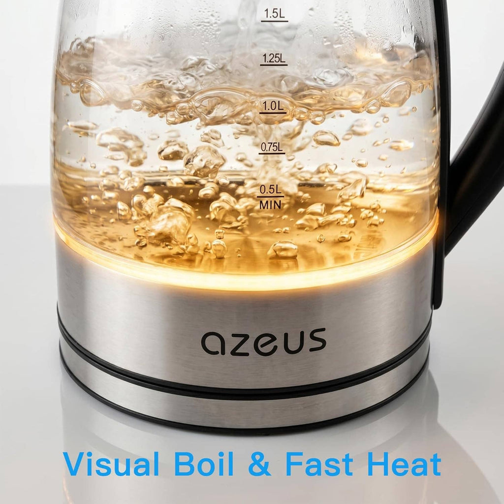 Electric glass kettle close-up with amber water, blue glow ring, visible volume markings