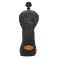 Black poker-card style driver golf club head cover with top grip and tan logo patch.