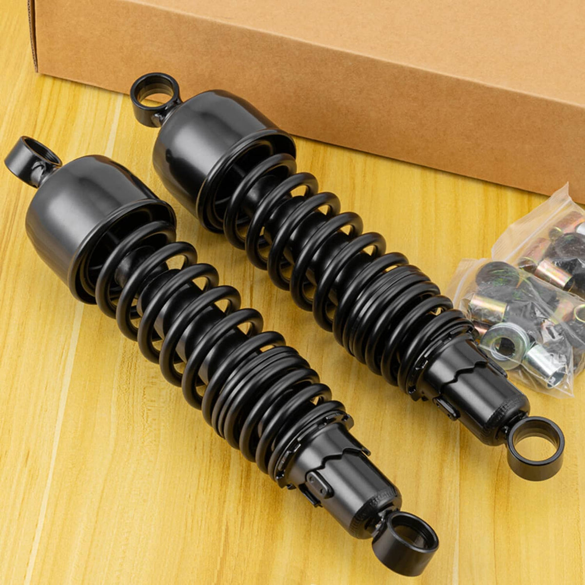 Pair of black rear suspension shocks with coil springs and included mounting parts