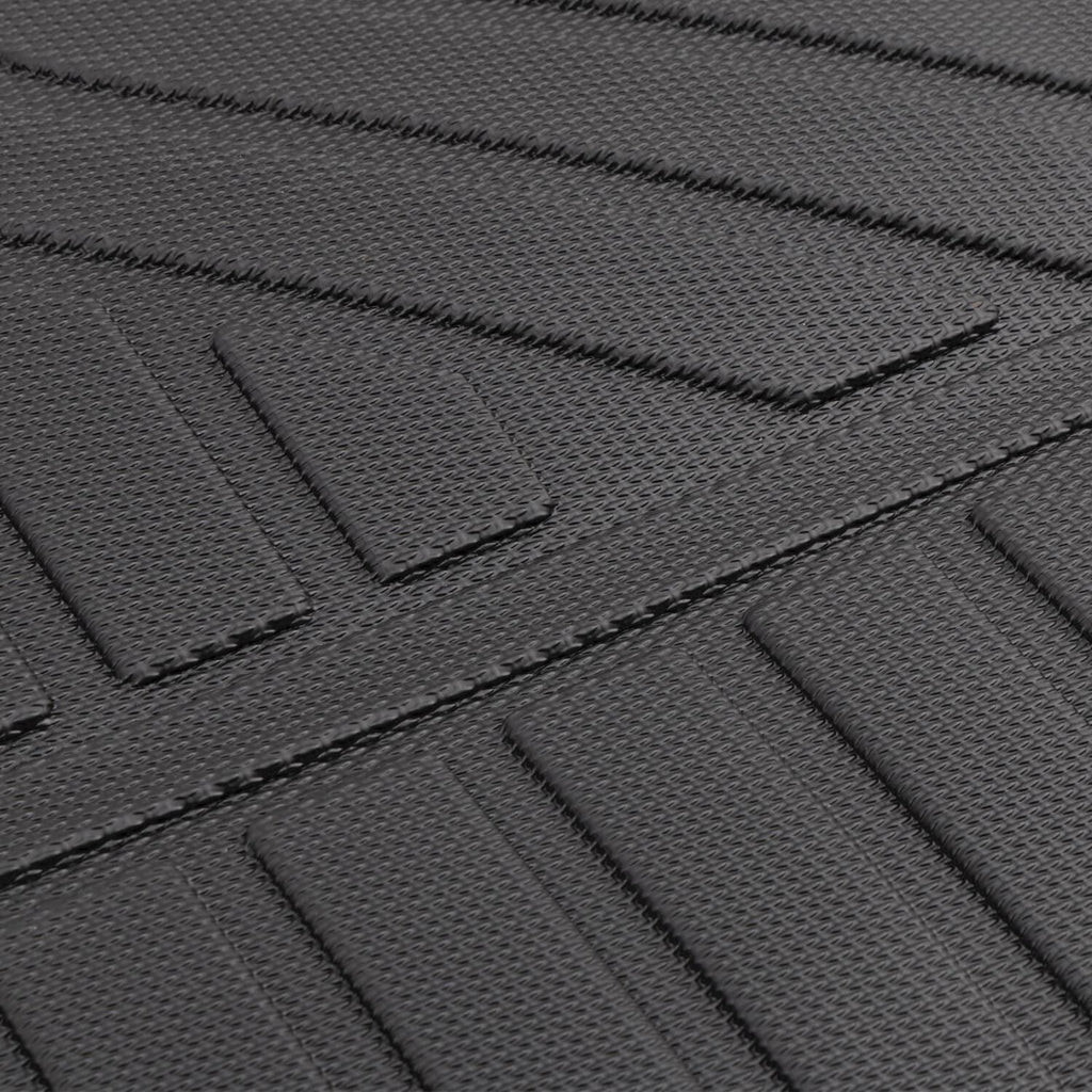 Dark floor mat liner close-up with stitched edge and raised grip ribs