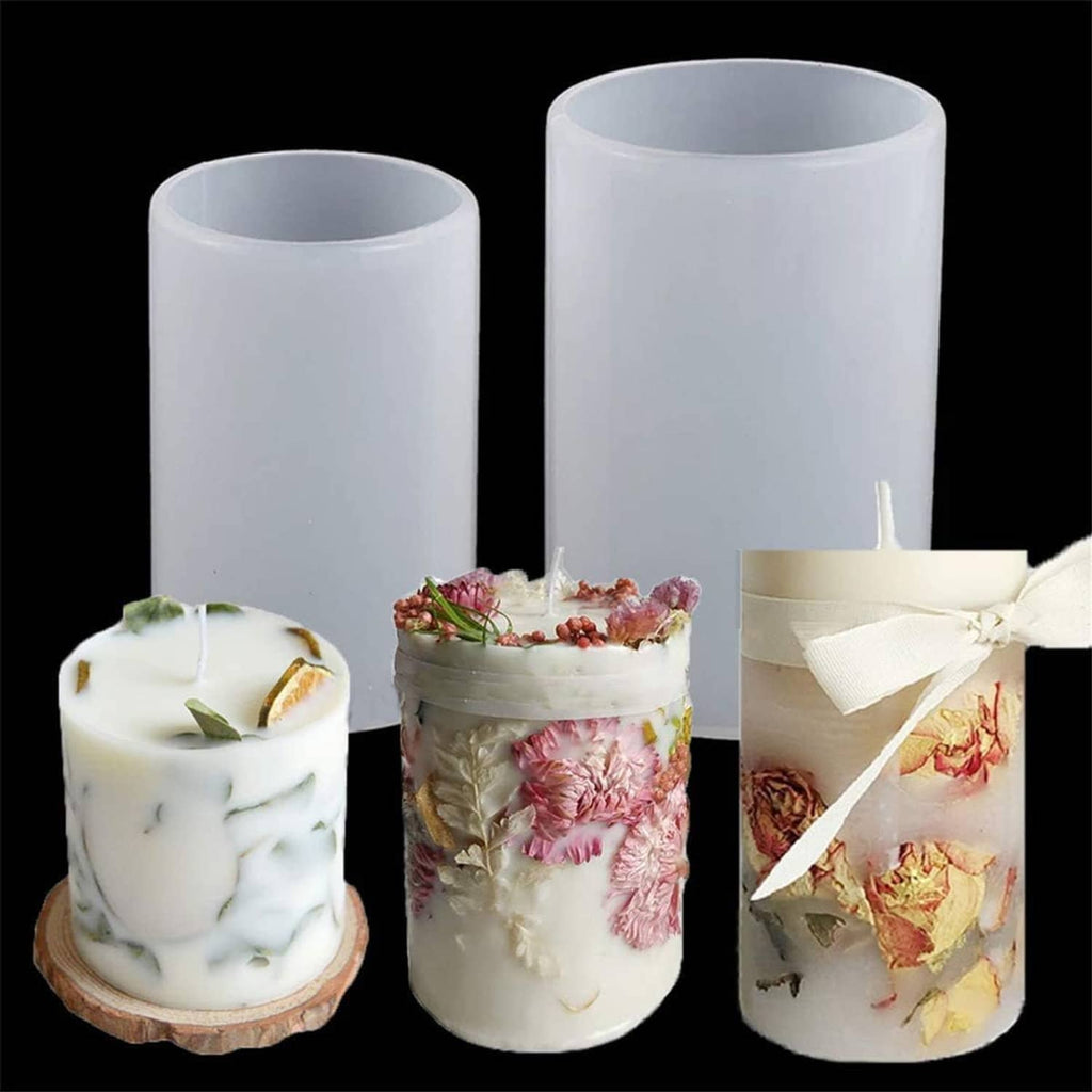 Three cylindrical pillar candles made in white silicone molds, with dried flowers and ribbon details.