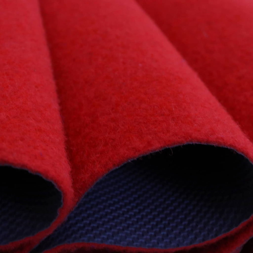 Red carpet runner close-up showing thick pile edge and dark non-slip backing