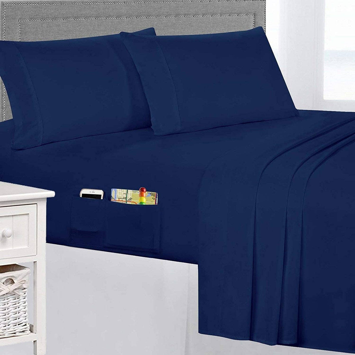 Navy queen sheet set close-up: pillowcase and fitted/flat sheet with smooth seams.