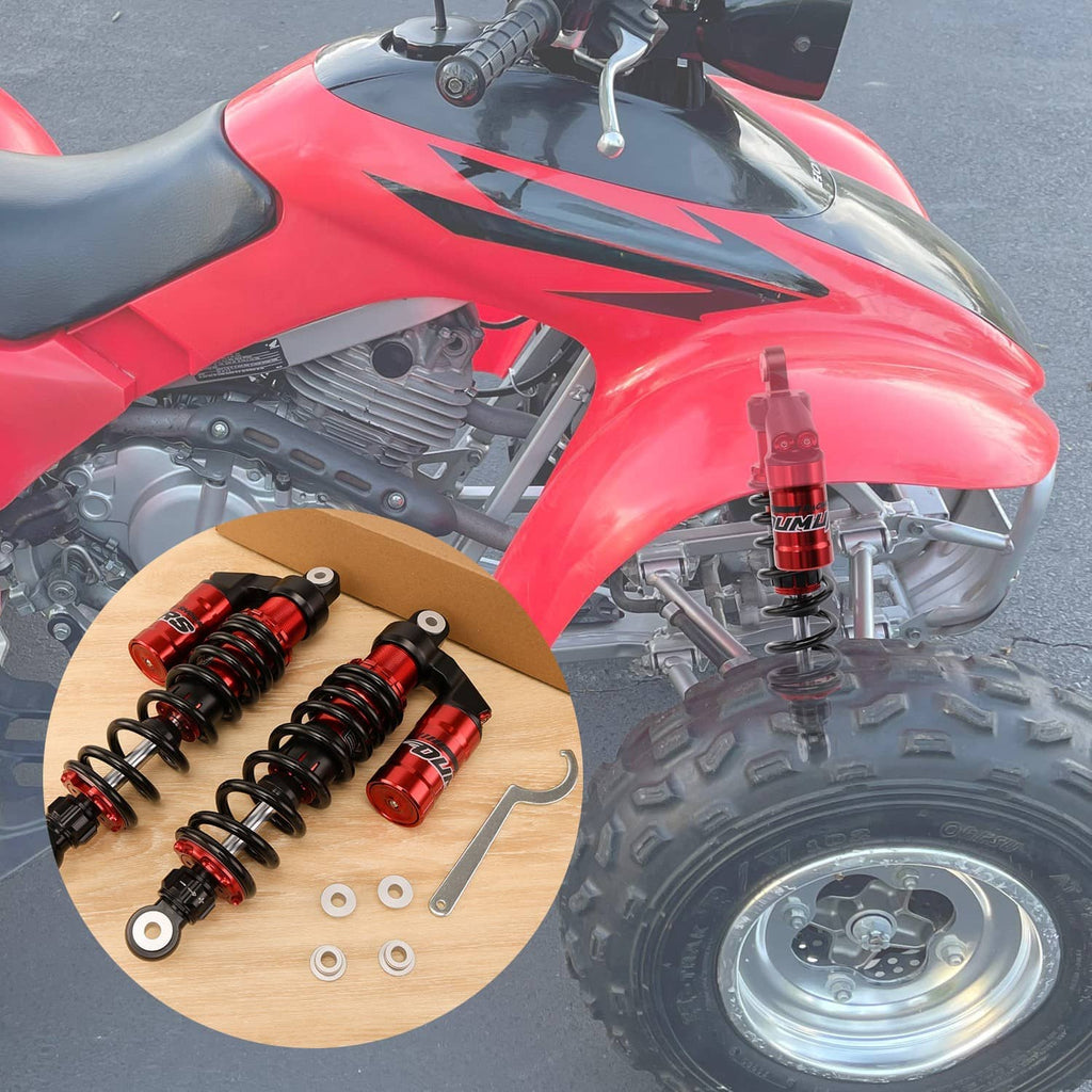 Red front air shocks on a red ATV, featuring black coil springs and mounting components