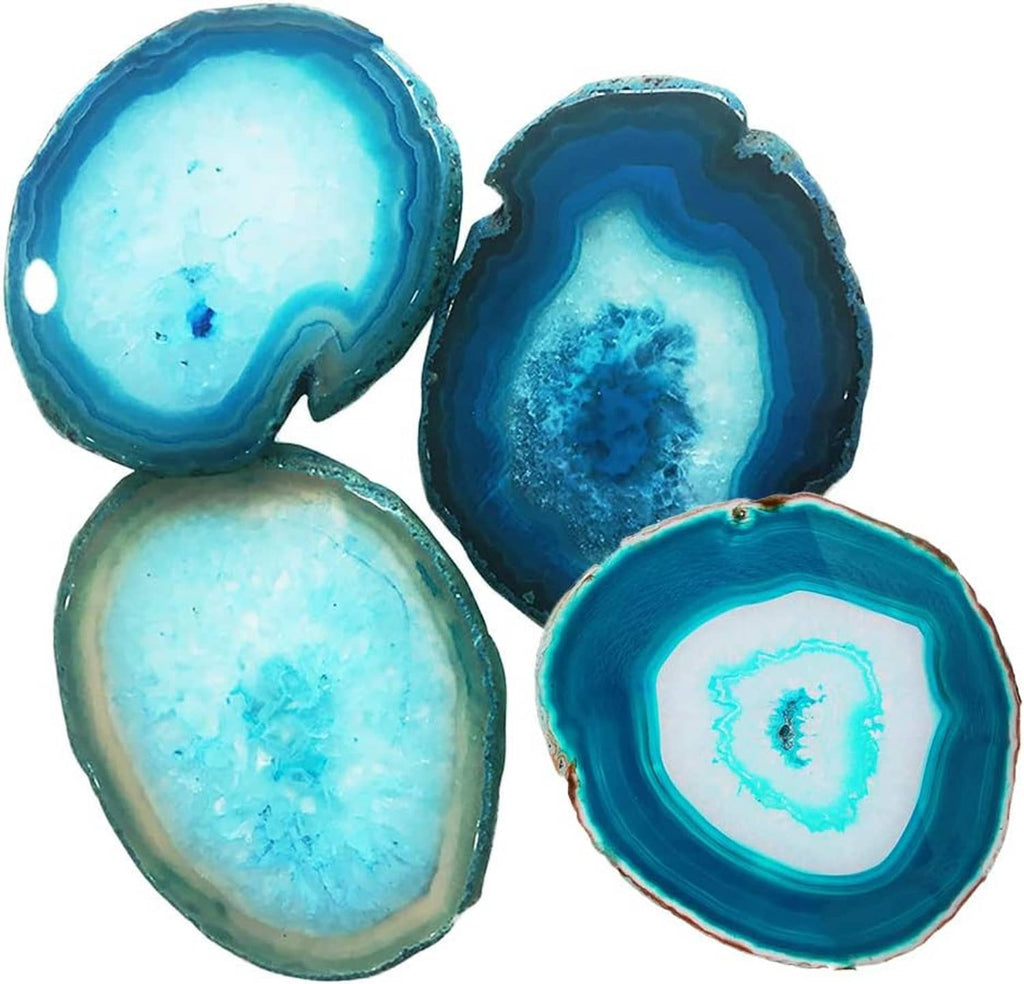 Four teal geode agate coasters showing blue center crystals and thick banded borders