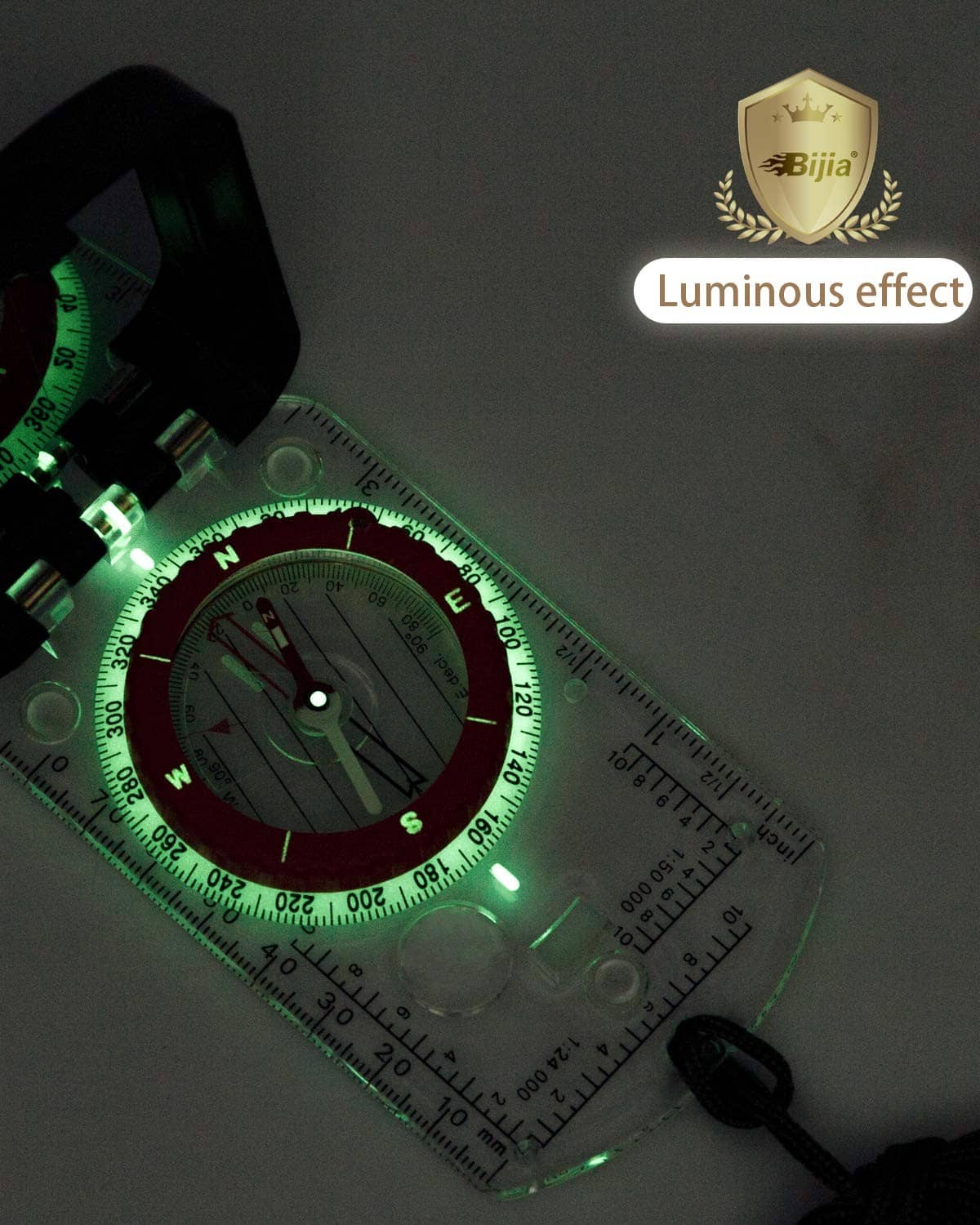 Luminous orienteering compass with clear scale and bright green glowing dial