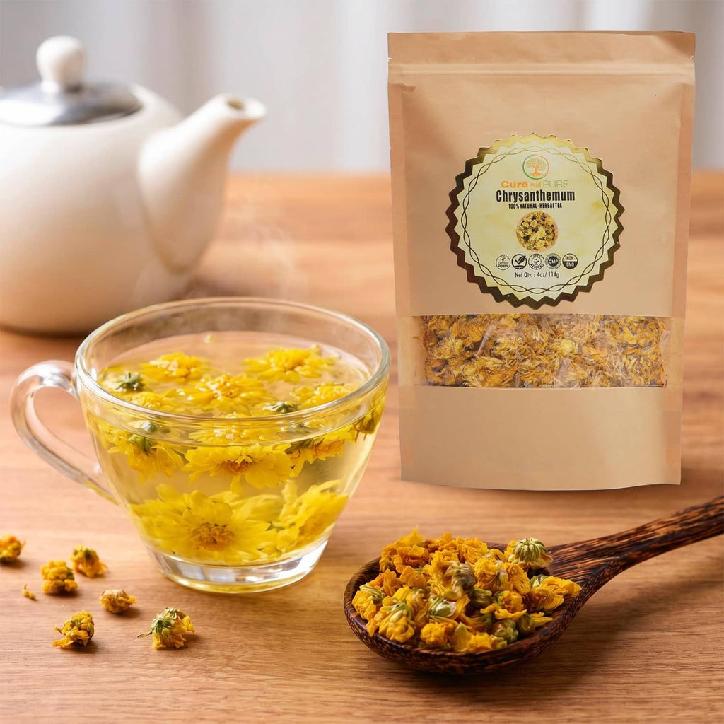 Organic chrysanthemum tea pouch with glass cup of golden brew and dried blossoms