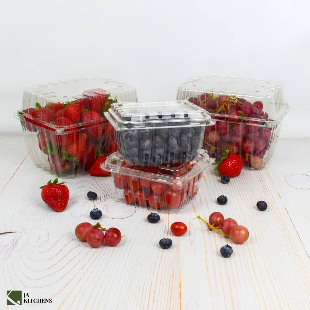 Set of clear plastic produce containers with hinged lids, filled with mixed berries