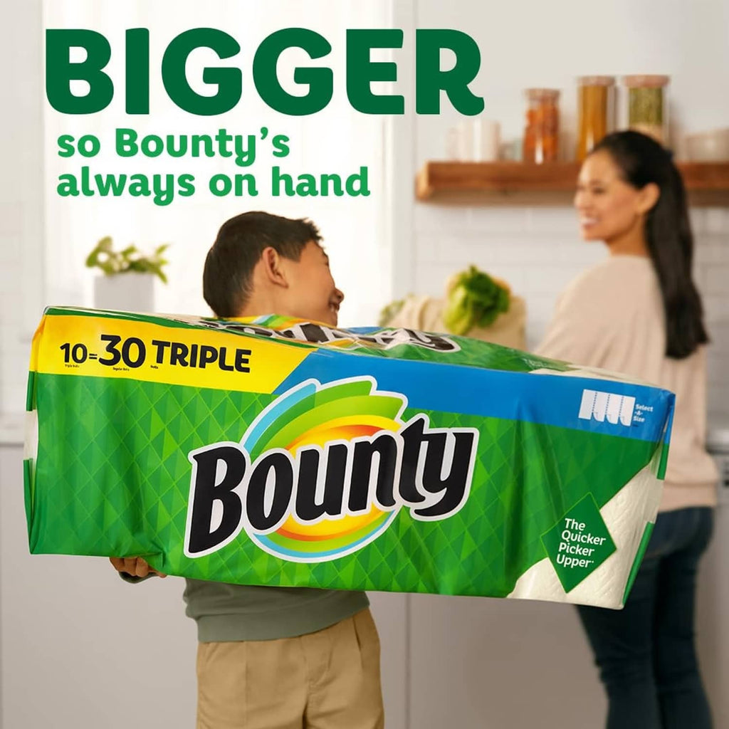 Paper towel triple-roll package held by a person in a home setting