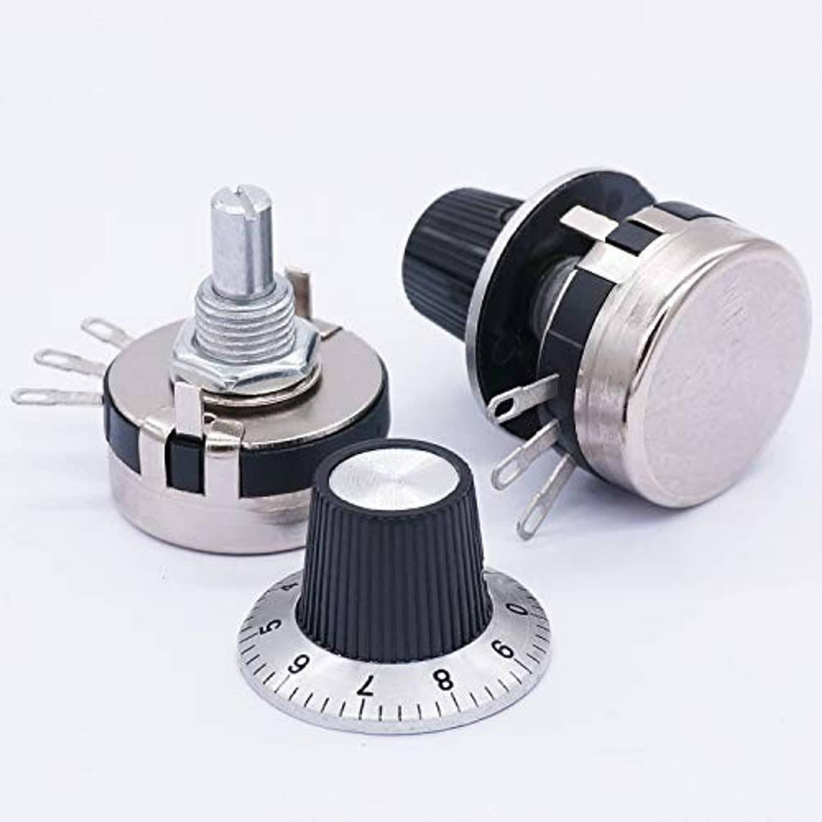 Rotary potentiometers set with ridged black knobs, silver housings, and mounting pins